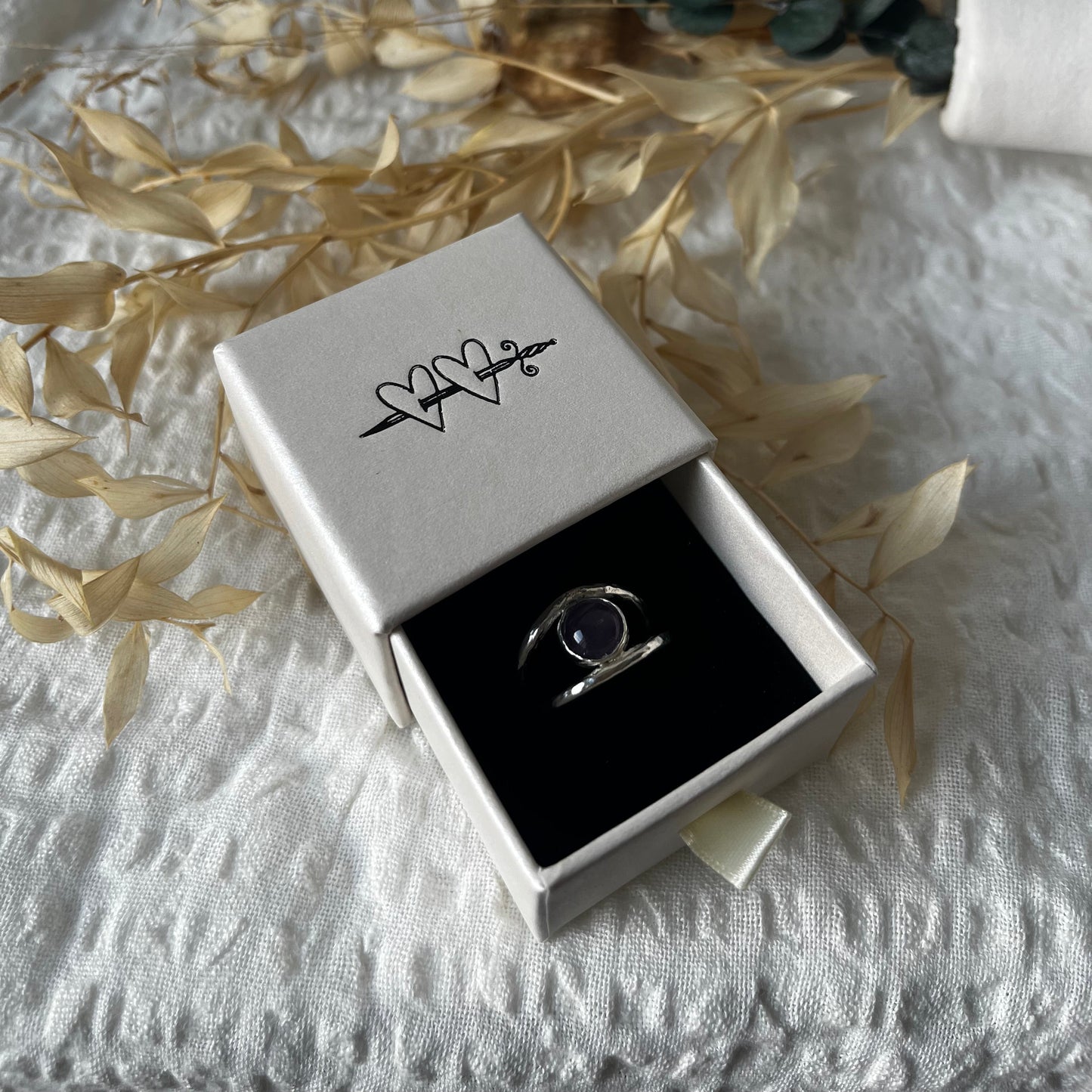 Double band ring hand-made in sterling silver with an amethyst in the center. Resembling an eye
