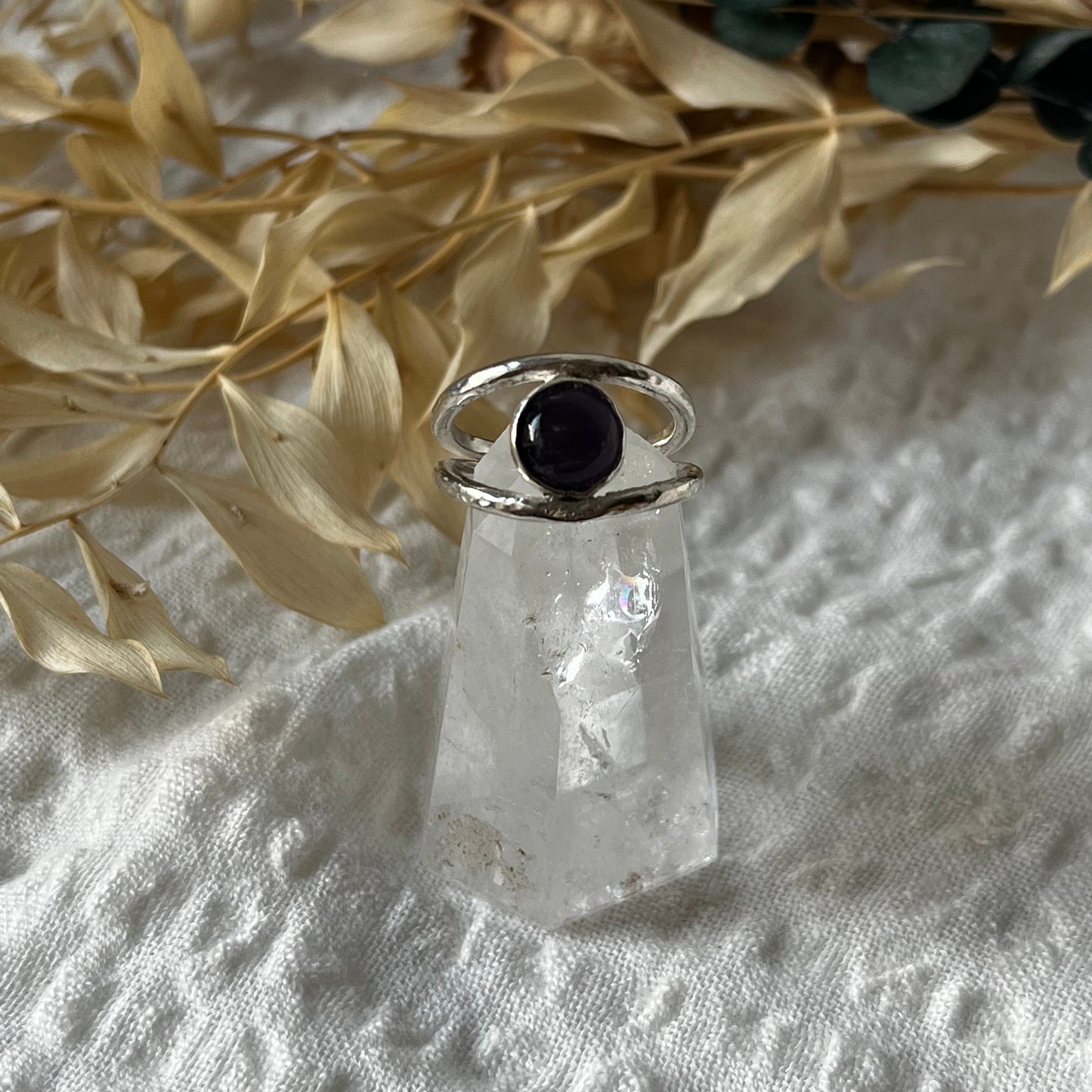 Double band ring hand-made in sterling silver with an amethyst in the center. Resembling an eye