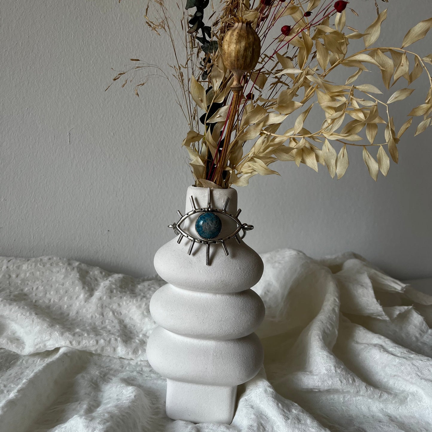 Handmade cuff in sterling silver with an eye with a stone in the center