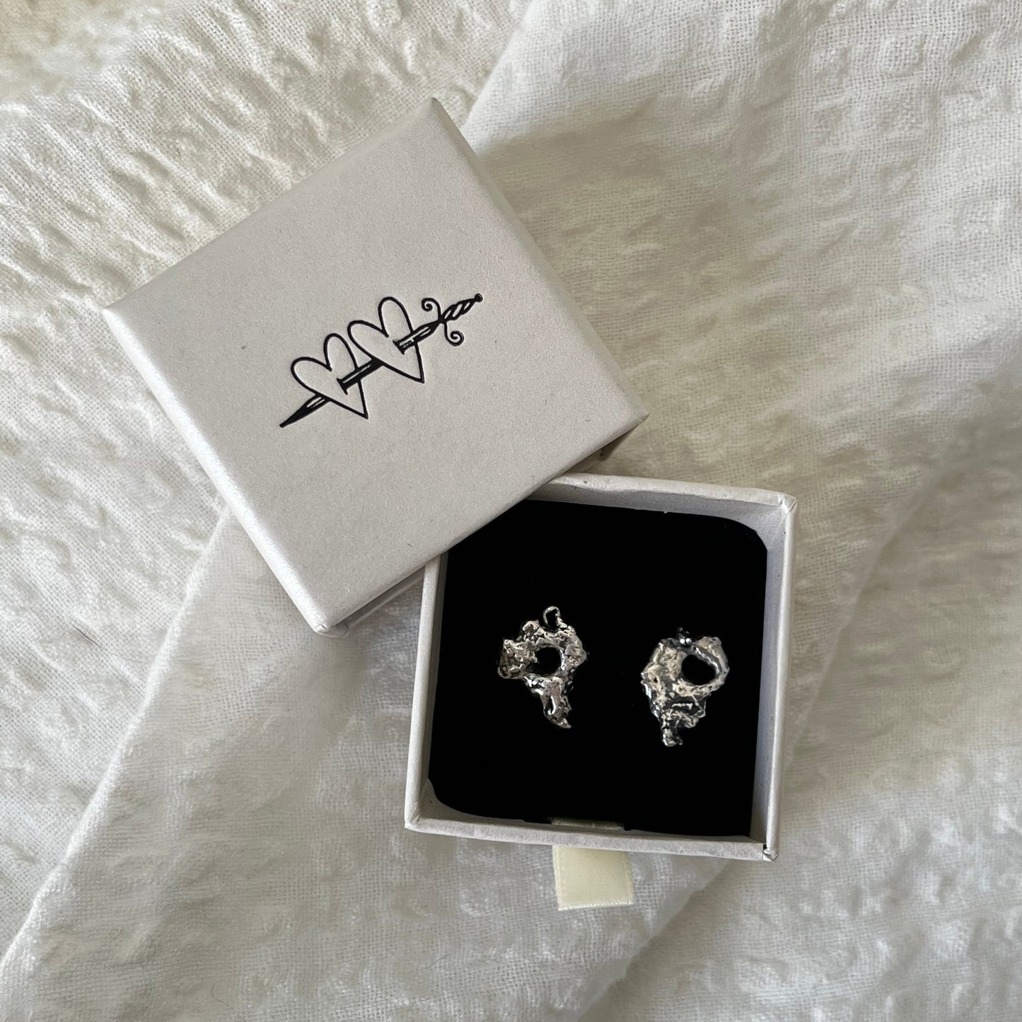 Pair of sterling silver earrings handmade with organic shapes.