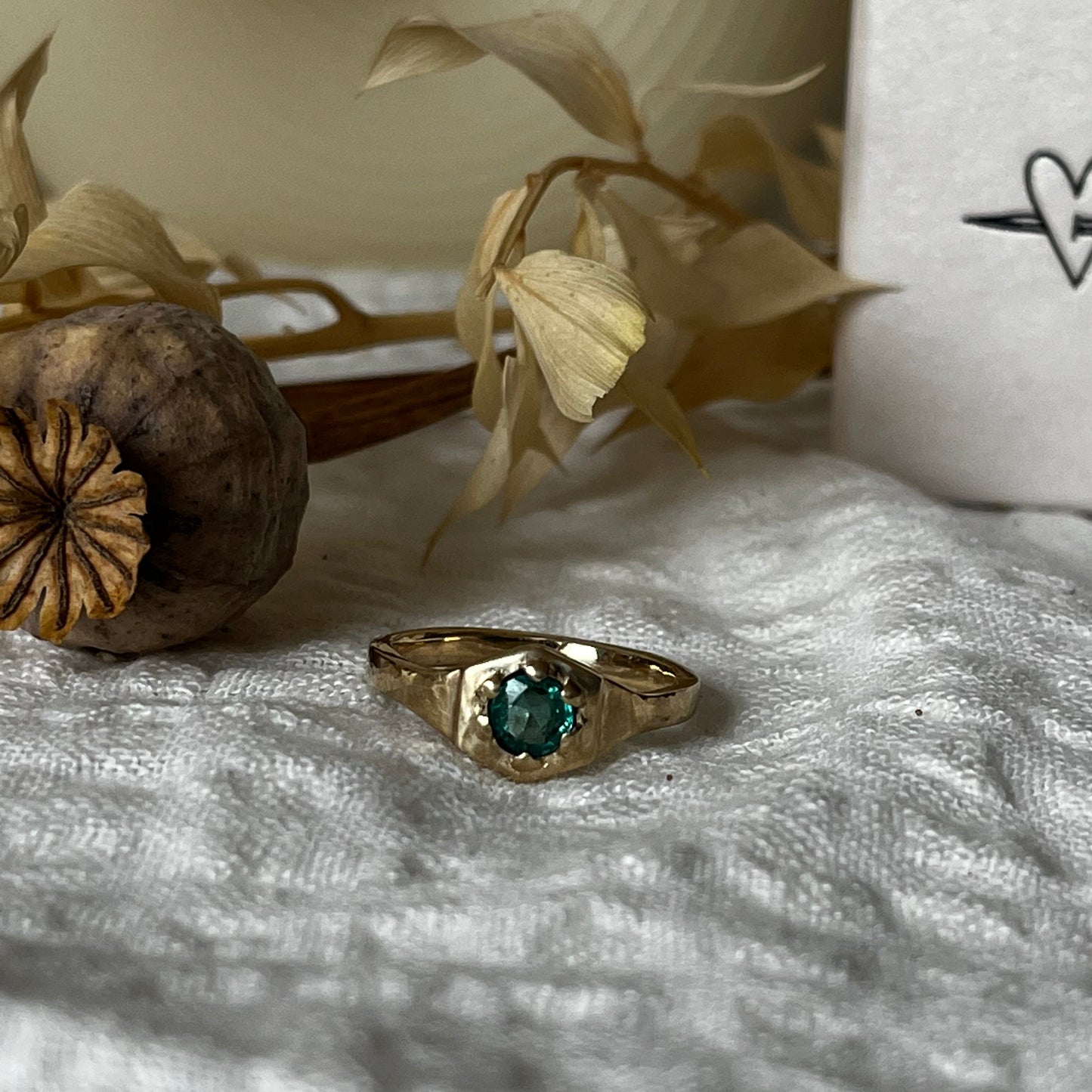 9kt solid gold engagement ring with a green emerald inside an hexagon