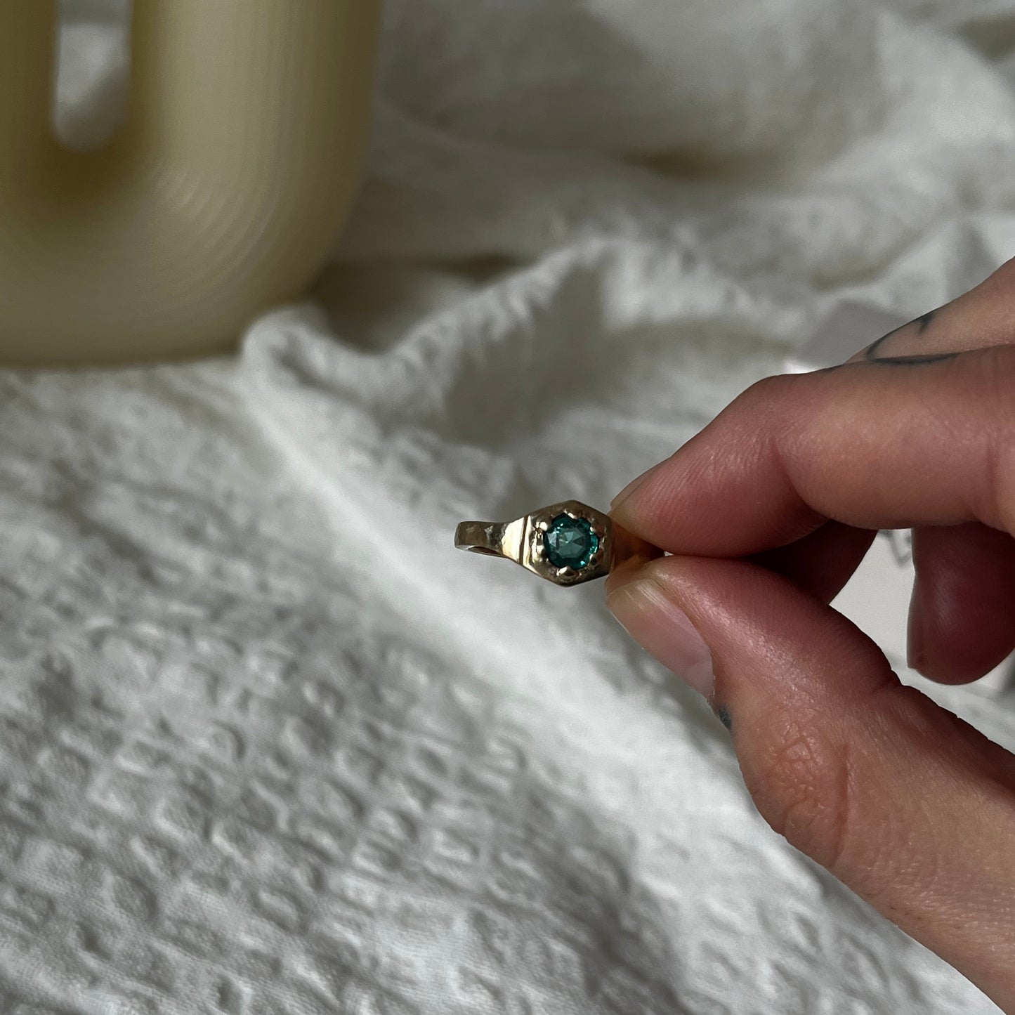 9kt solid gold engagement ring with a green emerald inside an hexagon