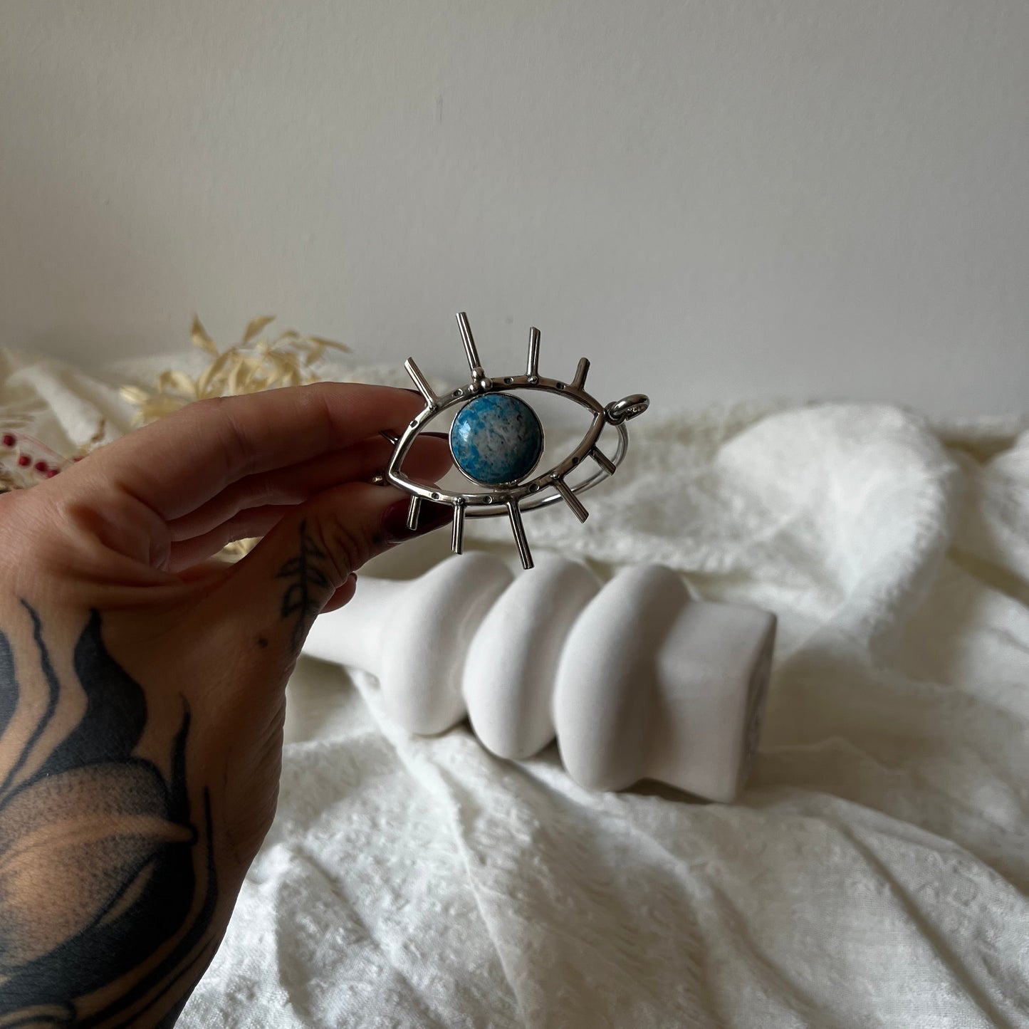Handmade cuff in sterling silver with an eye with a stone in the center
