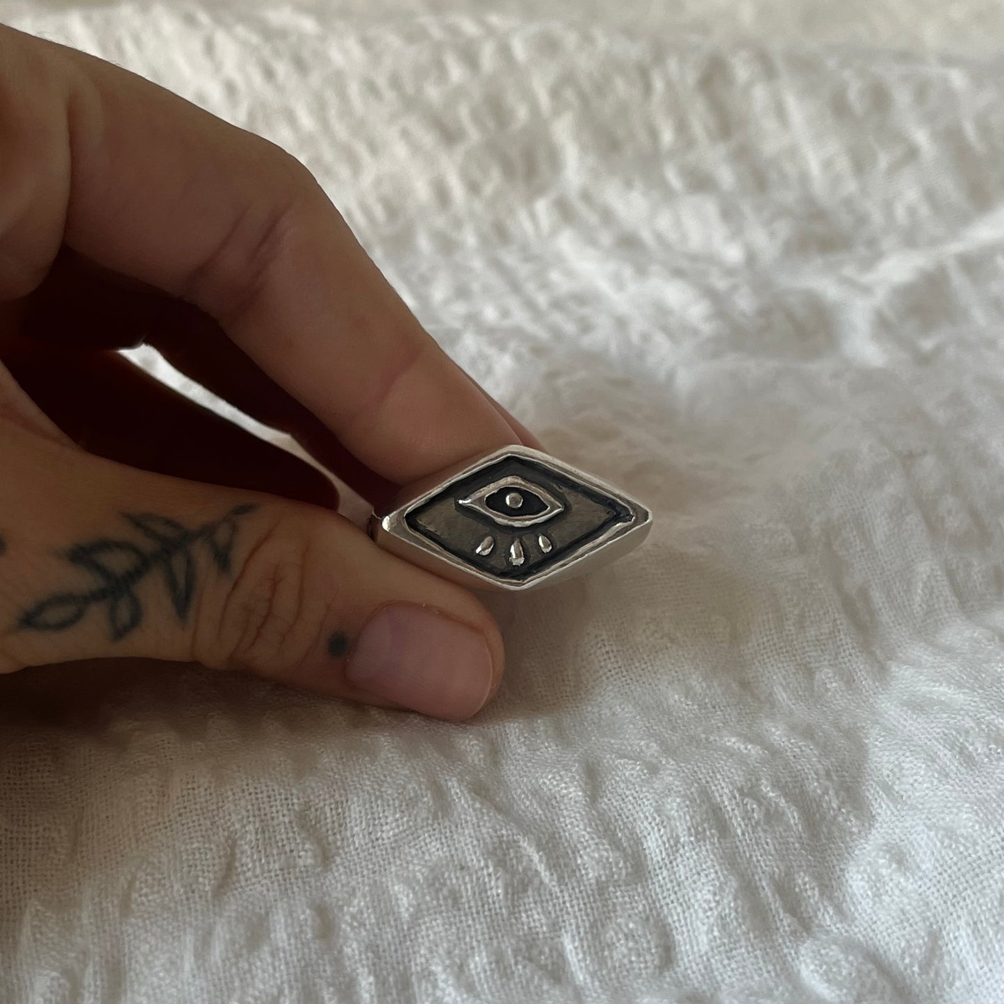 Signet ring with a hand carved eye design