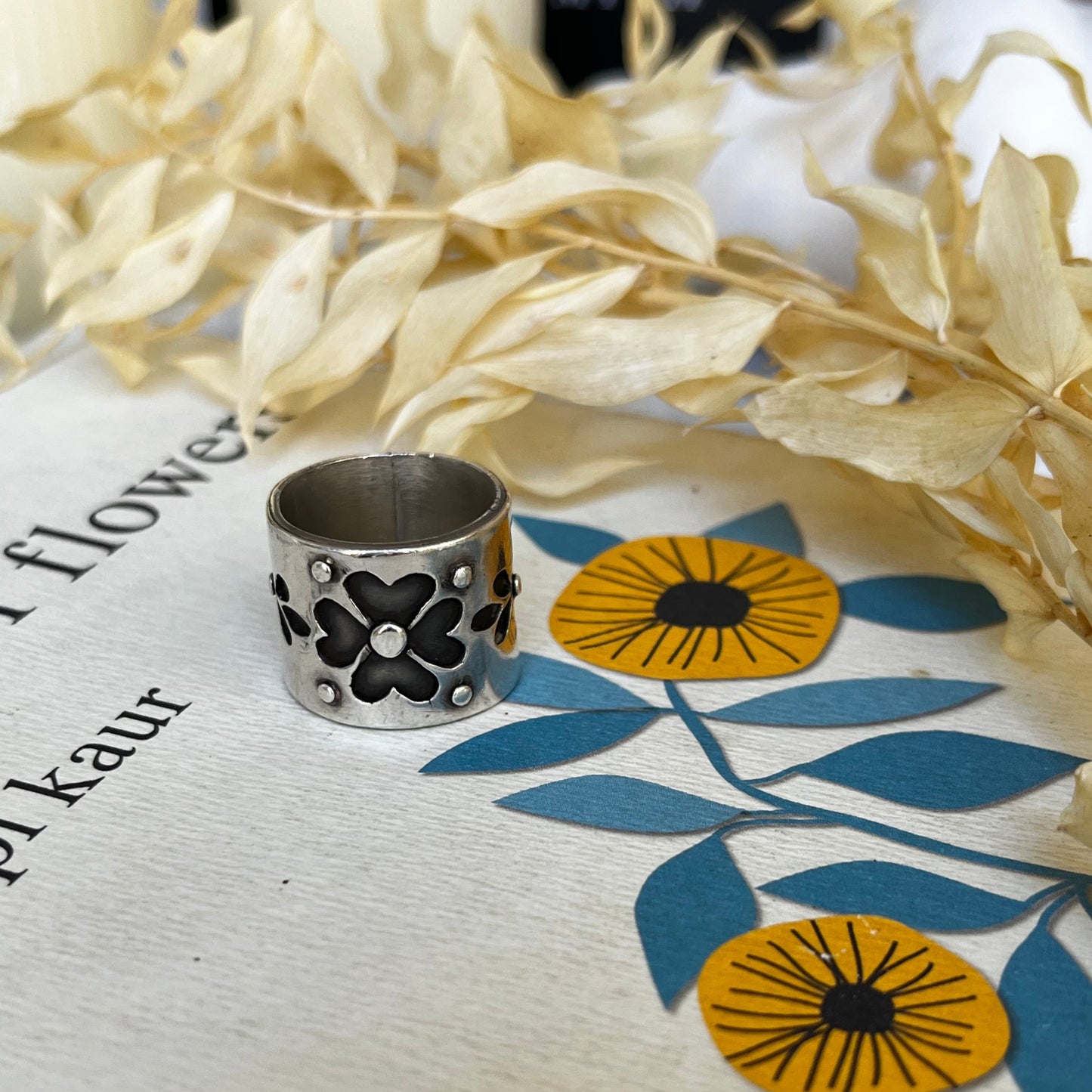 Handmade sterling silver ring with a ornamental flower design