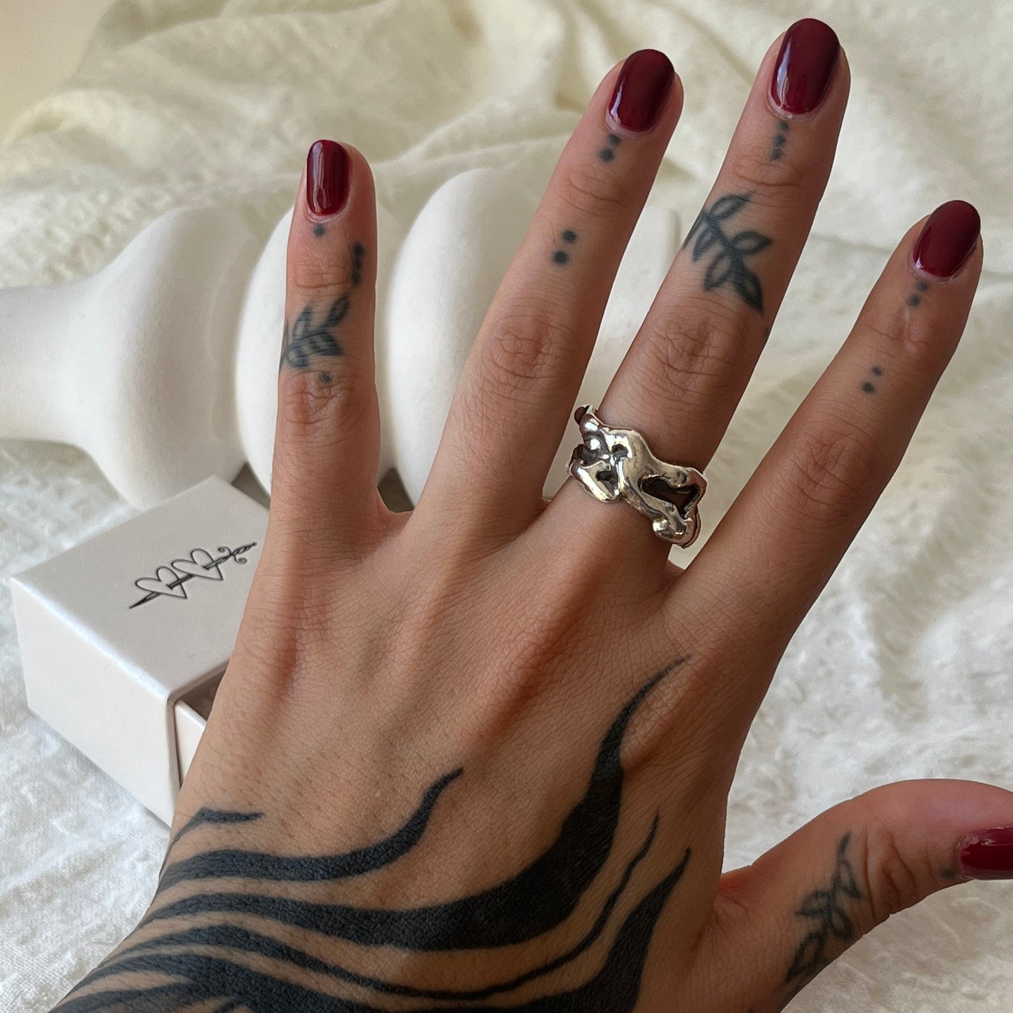 Hand made sterling silver ring with a molten design