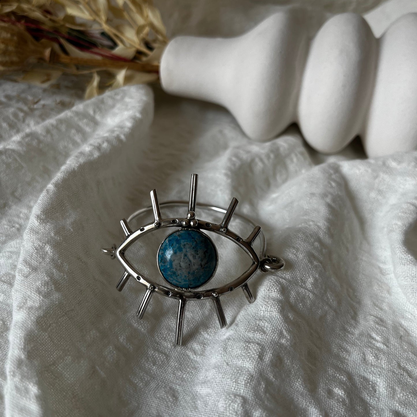 Handmade cuff in sterling silver with an eye with a stone in the center