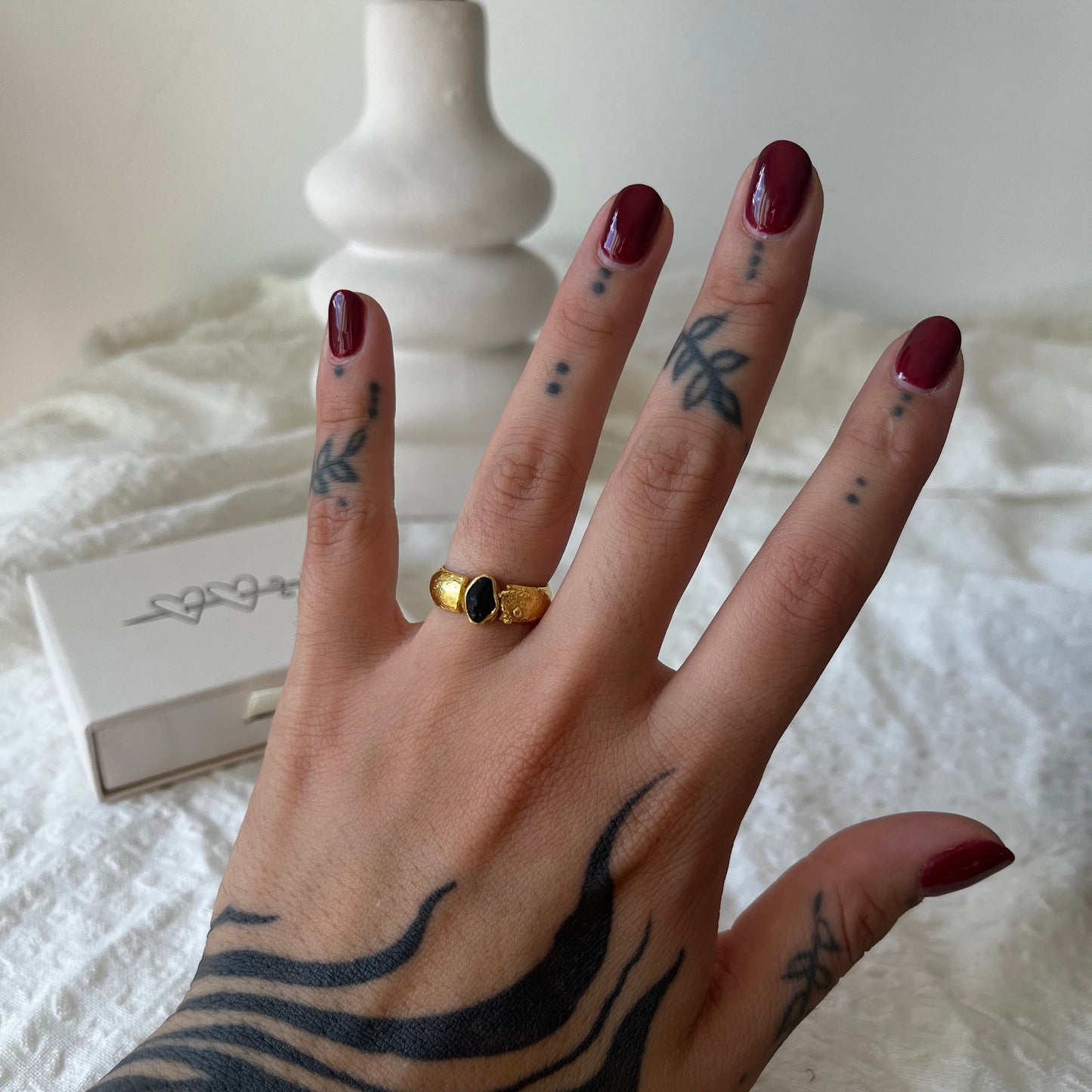 Organic handmade rings in silver and gold plated with a black stone in the center