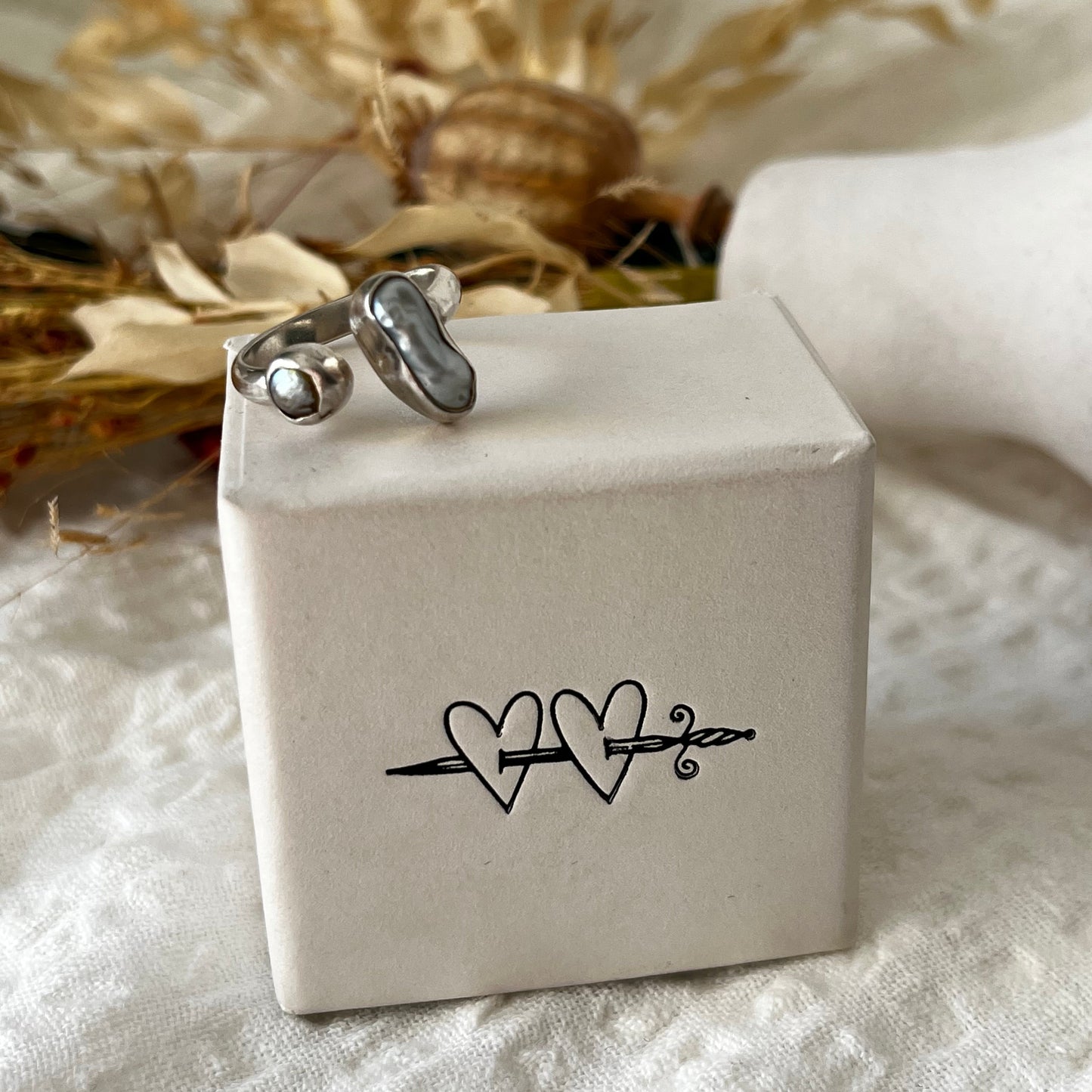 Handmade sterling silver ring with two fresh water pearls in an open band