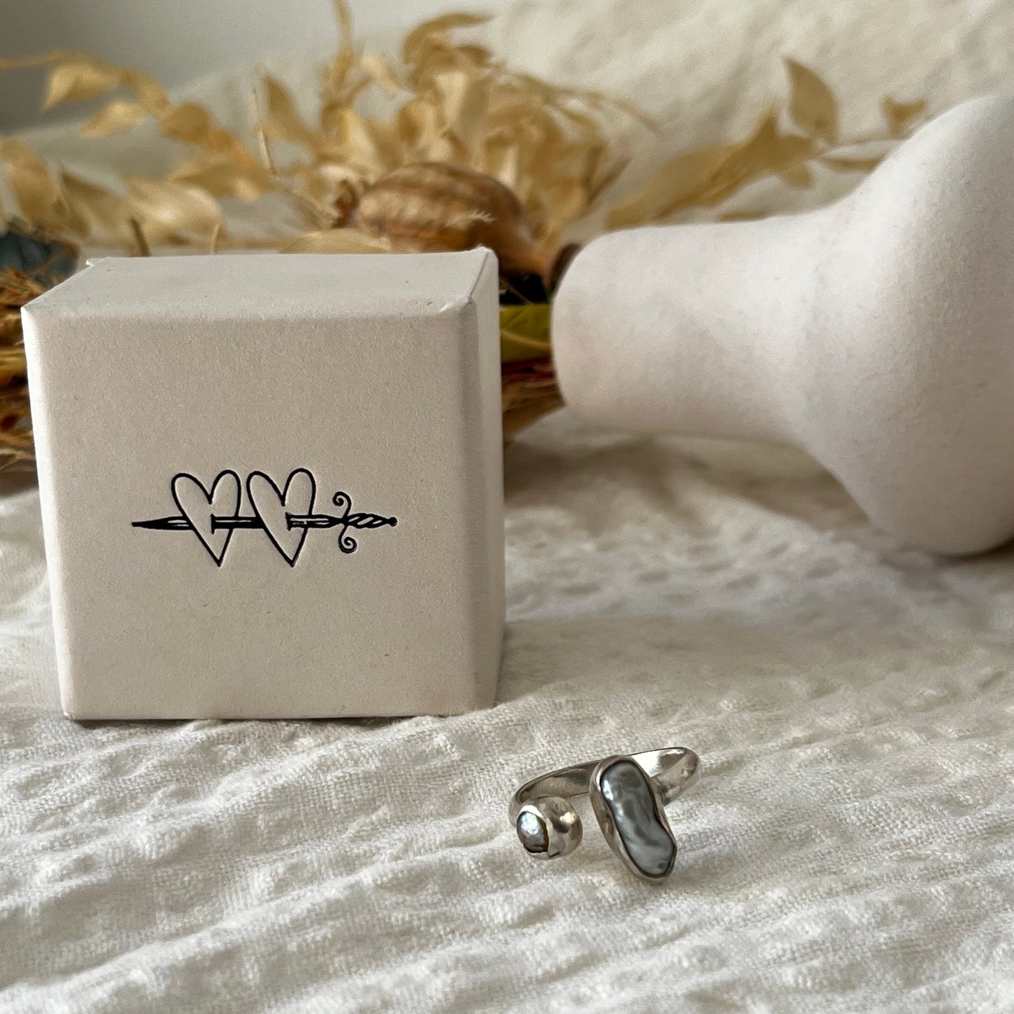 Handmade sterling silver ring with two fresh water pearls in an open band