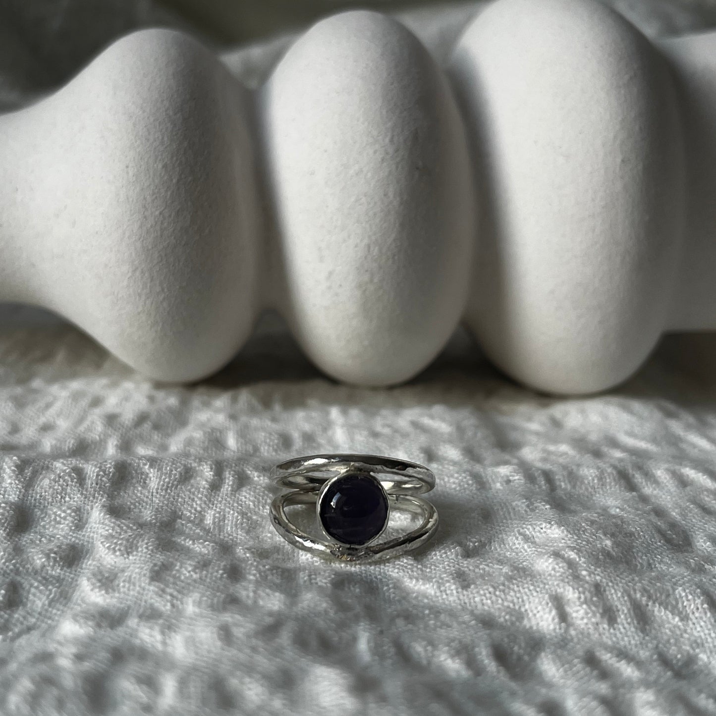 Double band ring hand-made in sterling silver with an amethyst in the center. Resembling an eye