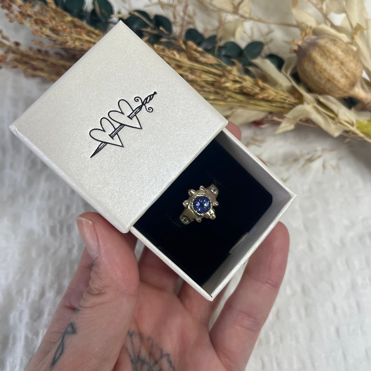 9kt Solid gold ring with a blue tanzanite and two cubic zirconias