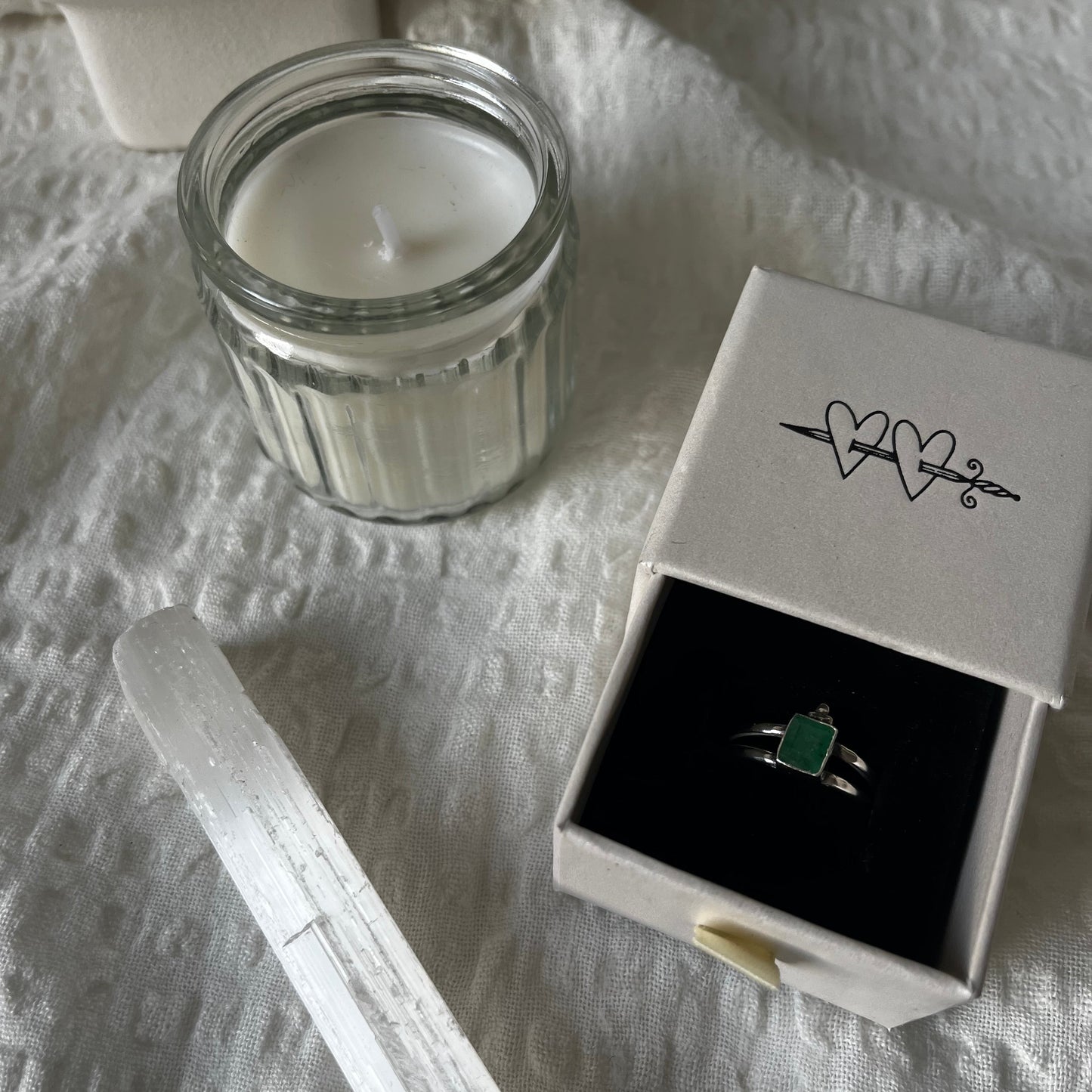 Double band sterling silver ring with a trio dot adornment and a green stone in the center