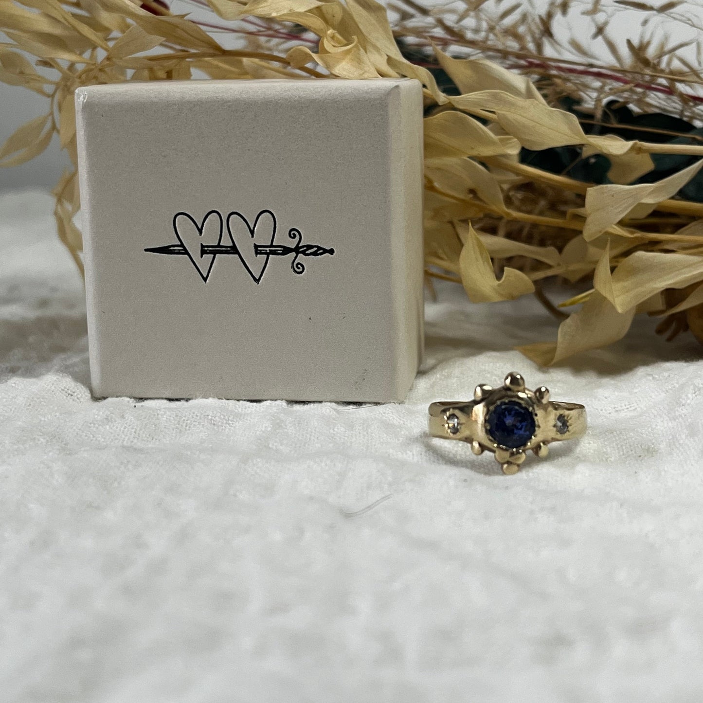 9kt Solid gold ring with a blue tanzanite and two cubic zirconias