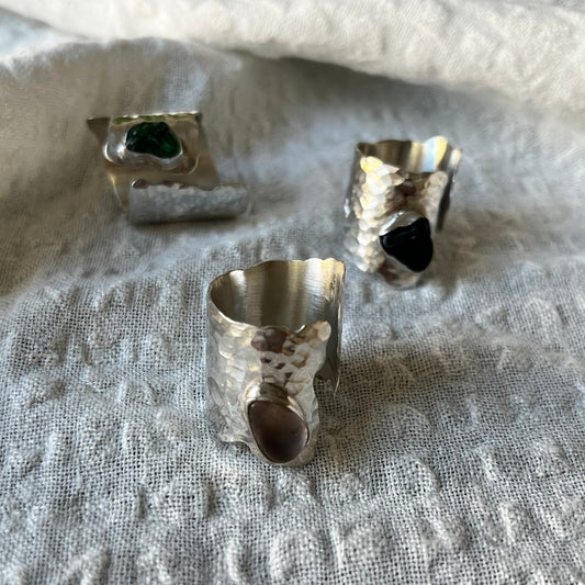 Wide band ring made of sterling silver with a sea glass center