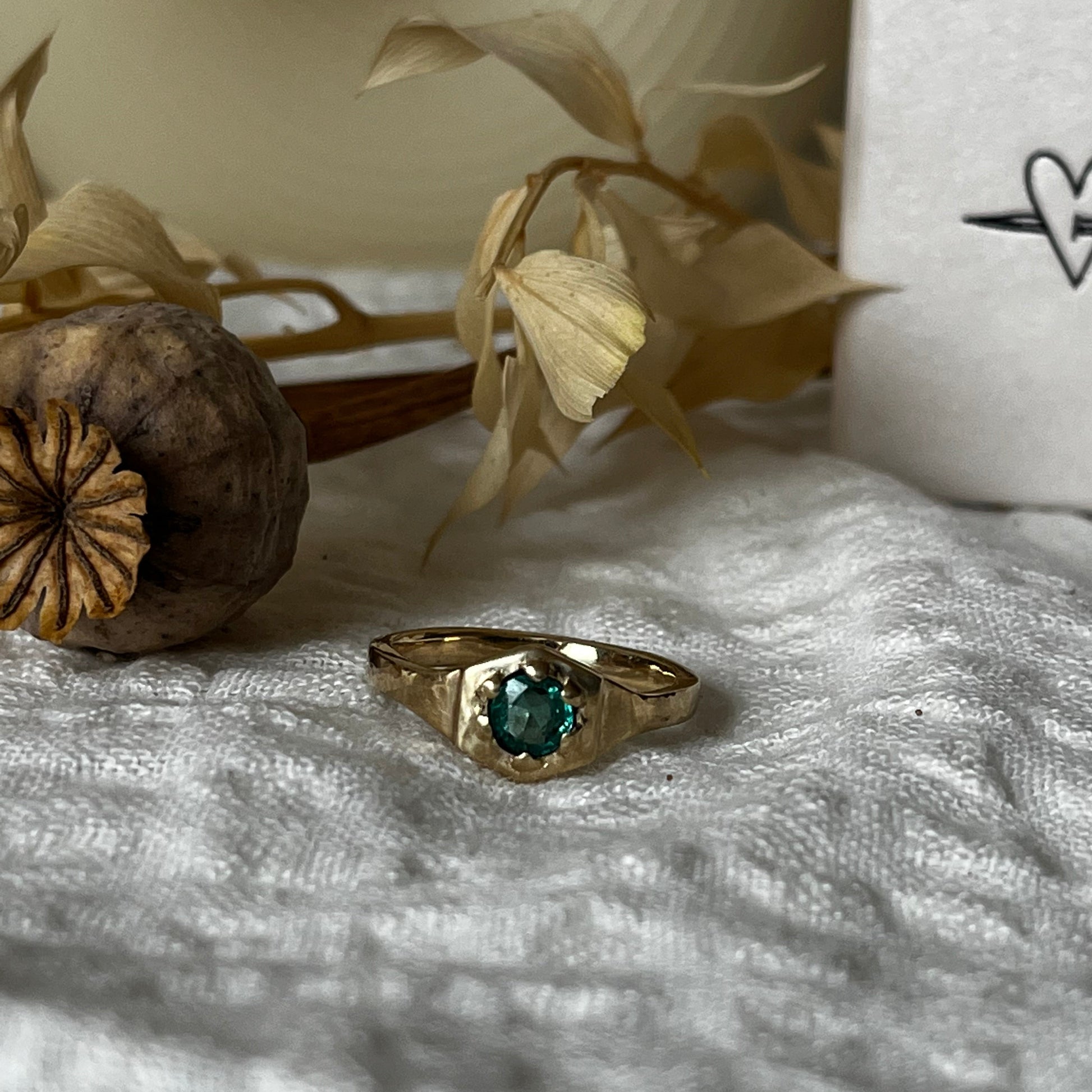 9kt solid gold engagement ring with a green emerald inside an hexagon