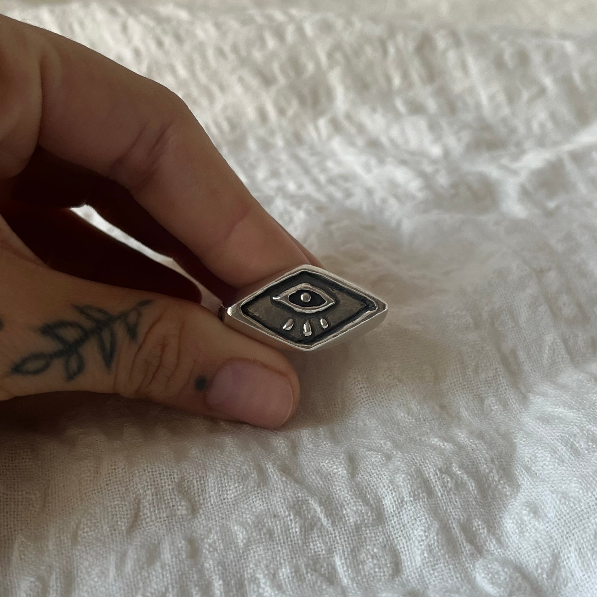 Signet ring with a hand carved eye design 