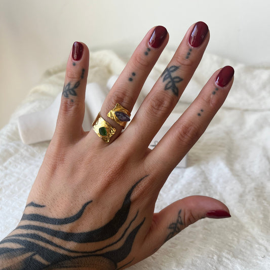 Open band gold plated ring made of sterling silver with a green sea glass in one end and a purple amethyst in the other