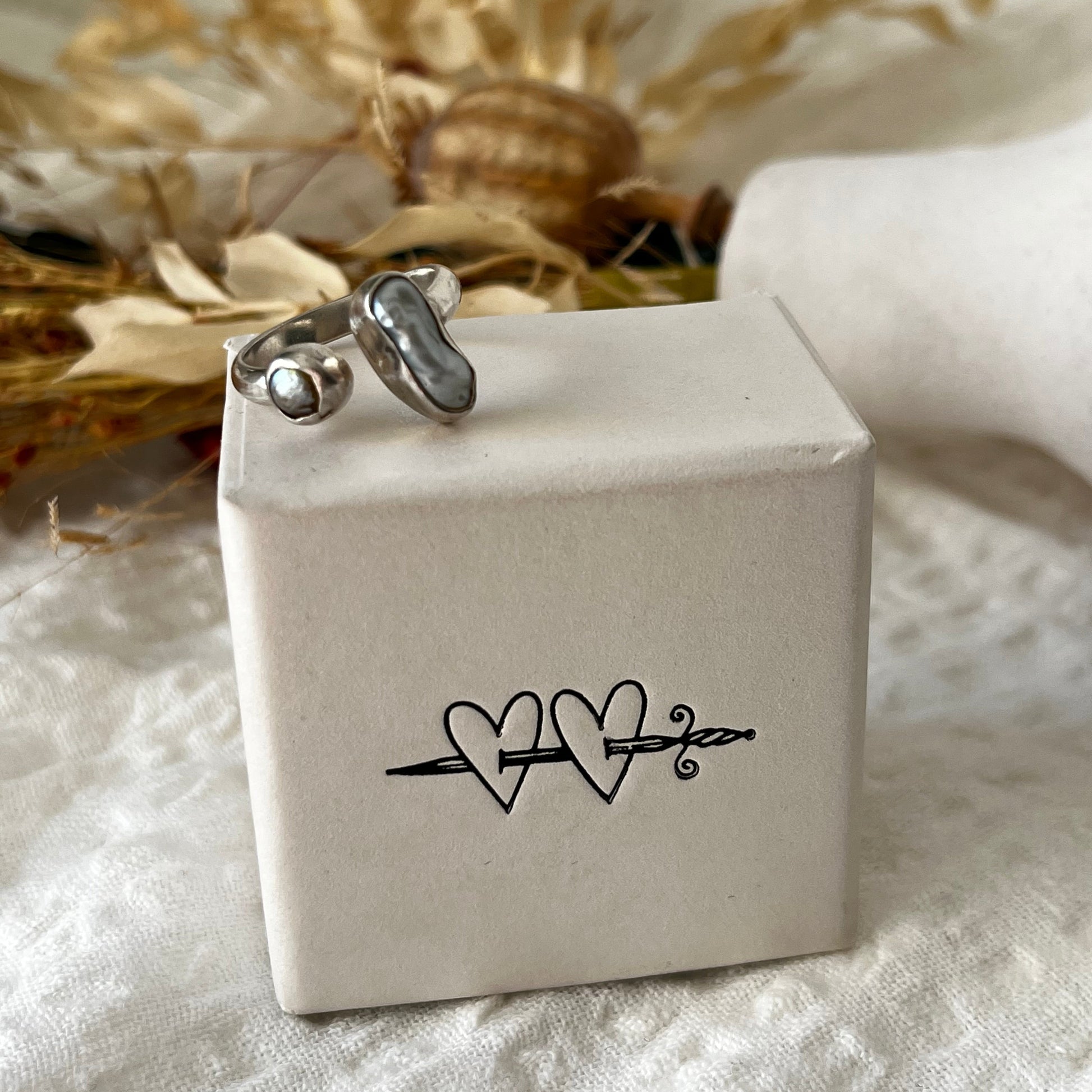 Handmade sterling silver ring with two fresh water pearls in an open band